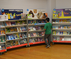 male student shopping at the book fair