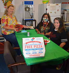 third grade teachers posing with their donated pizza lunch